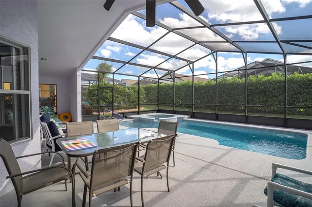 a dining room with furniture and a floor to ceiling window
