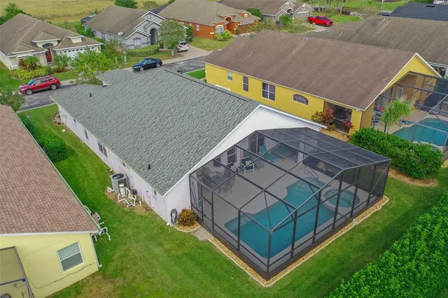 an aerial view of a house with a yard