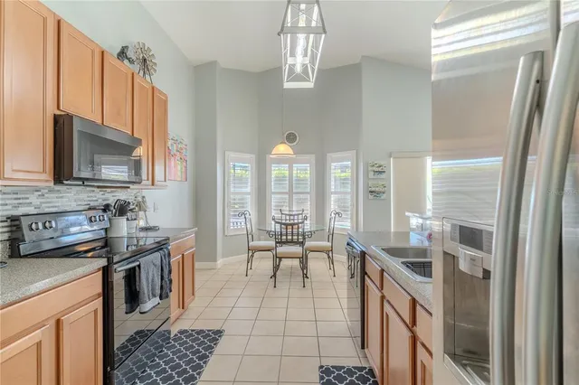 a kitchen with stainless steel appliances a sink stove and cabinets