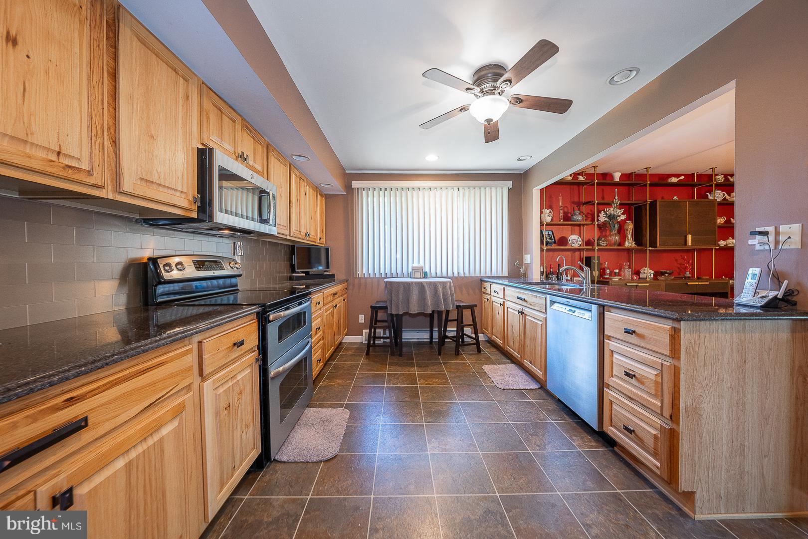 848 Mourning Dove Road Audubon, PA 19403 - Photo 23 of 86 a kitchen with stainless steel appliances granite countertop a stove top oven a sink dishwasher and cabinets with wooden floor