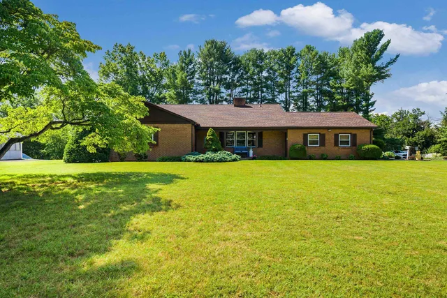 a kitchen with stainless steel appliances a white table chairs and a refrigerator