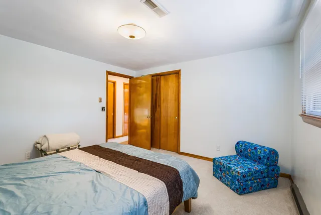 an aerial view of a residential houses with outdoor space and trees