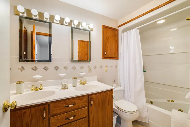 a bedroom with a bed a couch and a window