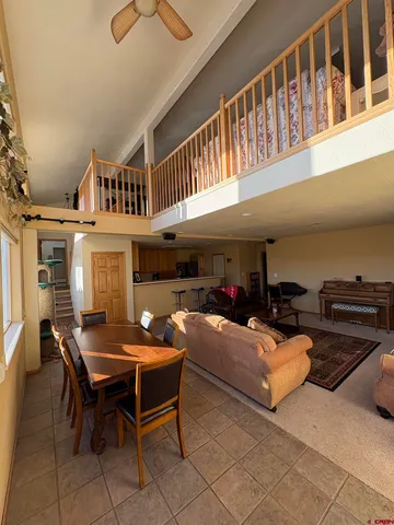 a dining room with furniture a rug and a chandelier