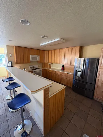 a kitchen with sink refrigerator and window
