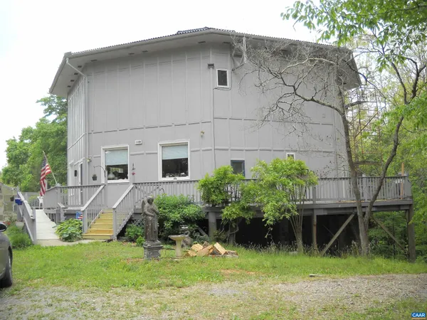 a front view of a house with a yard and potted plants