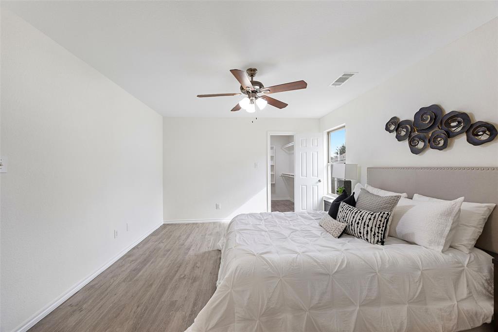 1605 Village Park Trail Burleson, TX 76028 - Photo 15 of 29 Bedroom featuring wood finished floors, a walk in closet, and ceiling fan