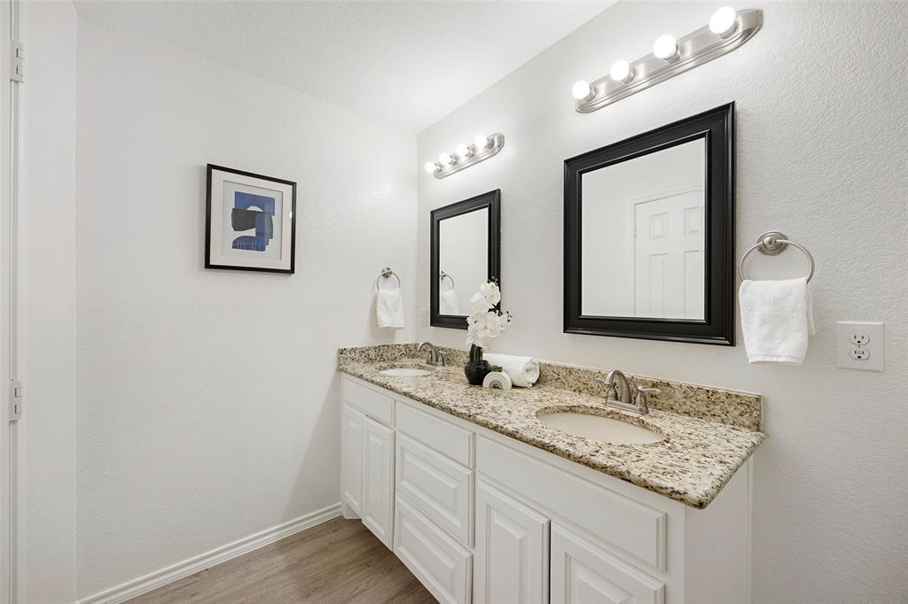 1605 Village Park Trail Burleson, TX 76028 - Photo 19 of 29 Bathroom featuring double vanity, light wood finished floors, and a textured wall