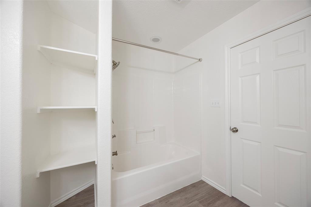 1605 Village Park Trail Burleson, TX 76028 - Photo 20 of 29 Full bath with wood finished floors, bathtub / shower combination, and a closet