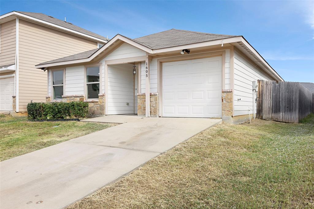 1605 Village Park Trail Burleson, TX 76028 - Photo 2 of 29 Single story home with a shingled roof, an attached garage, stone siding, and concrete driveway