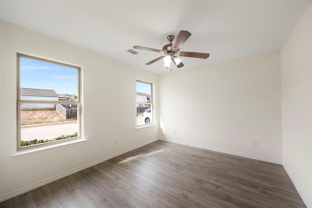 1605 Village Park Trail Burleson, TX 76028 - Photo 22 of 29 Bedroom two featuring dark wood-style flooring and a ceiling fan