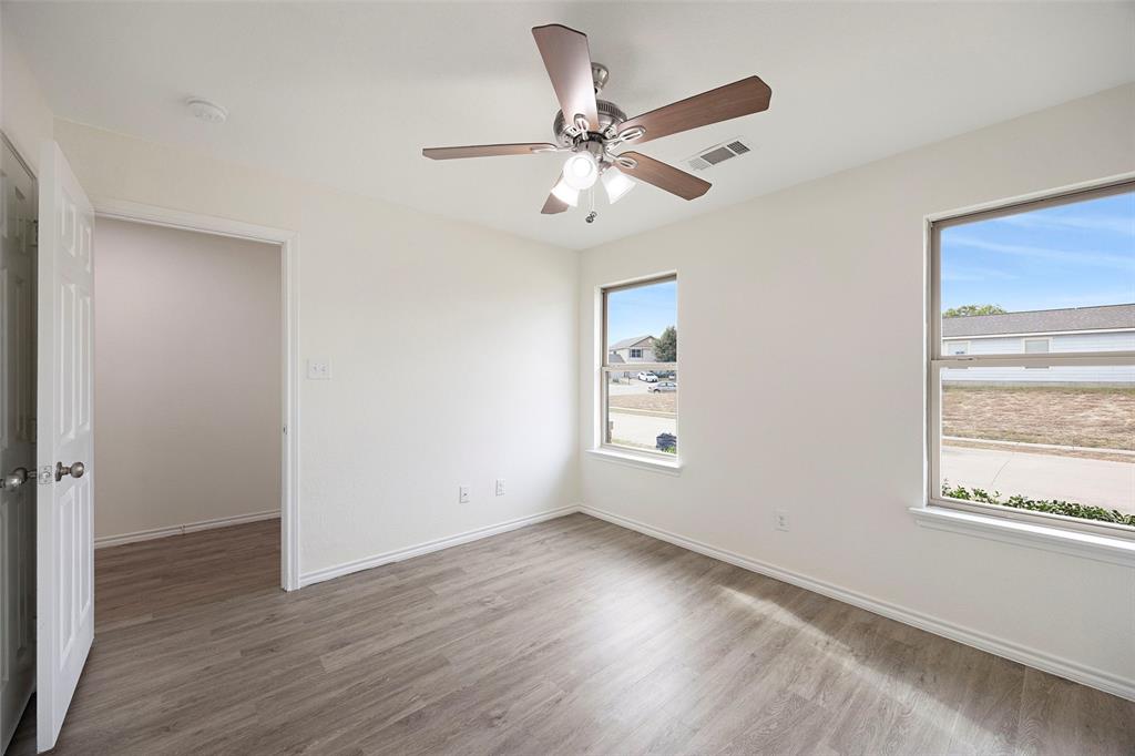 1605 Village Park Trail Burleson, TX 76028 - Photo 23 of 29 Bedroom two featuring light wood finished floors and a ceiling fan