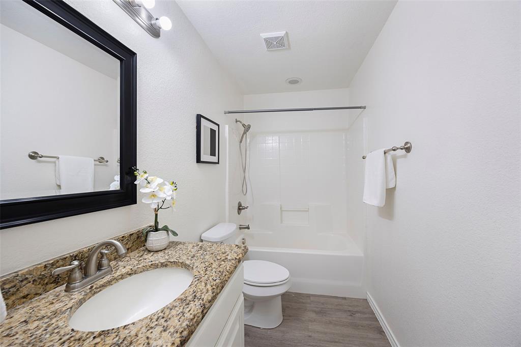 1605 Village Park Trail Burleson, TX 76028 - Photo 24 of 29 Full bath with washtub / shower combination, light wood-type flooring, and vanity