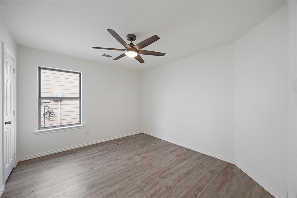 1605 Village Park Trail Burleson, TX 76028 - Photo 25 of 29 Bedroom three with light wood-type flooring and a ceiling fan
