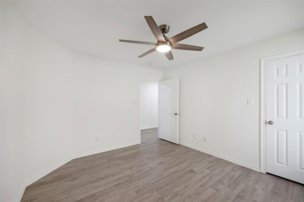 1605 Village Park Trail Burleson, TX 76028 - Photo 26 of 29 Bedroom three with light wood finished floors and a ceiling fan