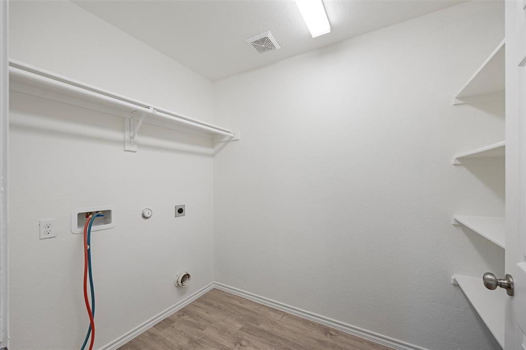 1605 Village Park Trail Burleson, TX 76028 - Photo 27 of 29 Large Washroom and pantry featuring light wood-style flooring, gas dryer hookup, hookup for a washing machine, and electric dryer hookup