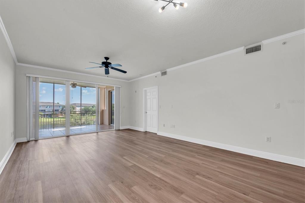 7069 Key Haven Road, Unit 302 Seminole, FL 33777 - Photo 13 of 65 wooden floor in an empty room with a window