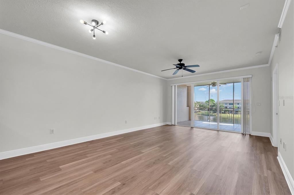 7069 Key Haven Road, Unit 302 Seminole, FL 33777 - Photo 14 of 65 wooden floor in an empty room with a window