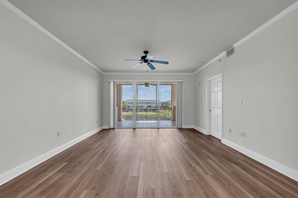7069 Key Haven Road, Unit 302 Seminole, FL 33777 - Photo 15 of 65 a view of an empty room with wooden floor and a window