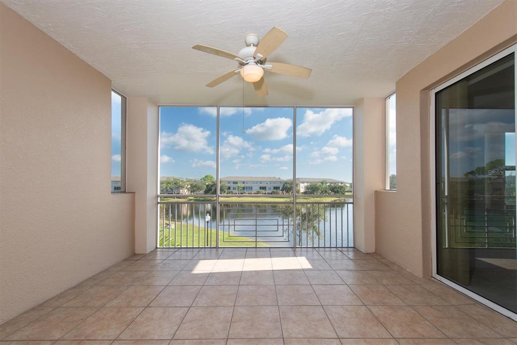 7069 Key Haven Road, Unit 302 Seminole, FL 33777 - Photo 19 of 65 a view of a livingroom with a ceiling fan and a large window