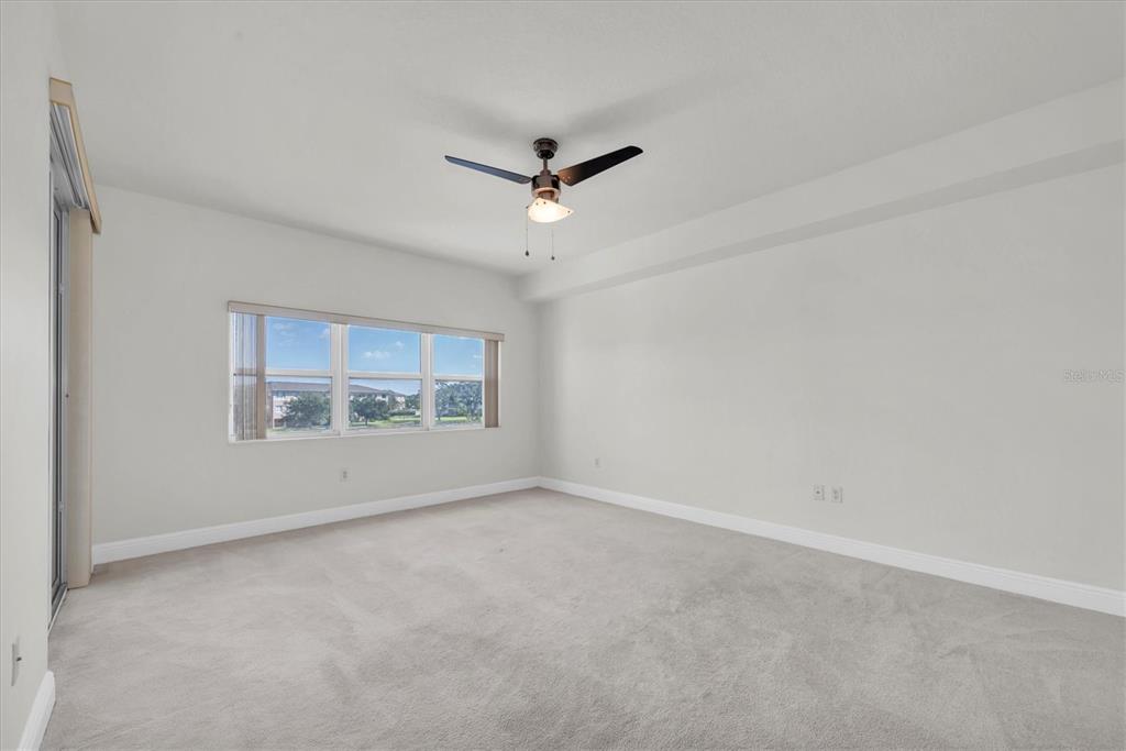 7069 Key Haven Road, Unit 302 Seminole, FL 33777 - Photo 22 of 65 an empty room with a ceiling fan and window