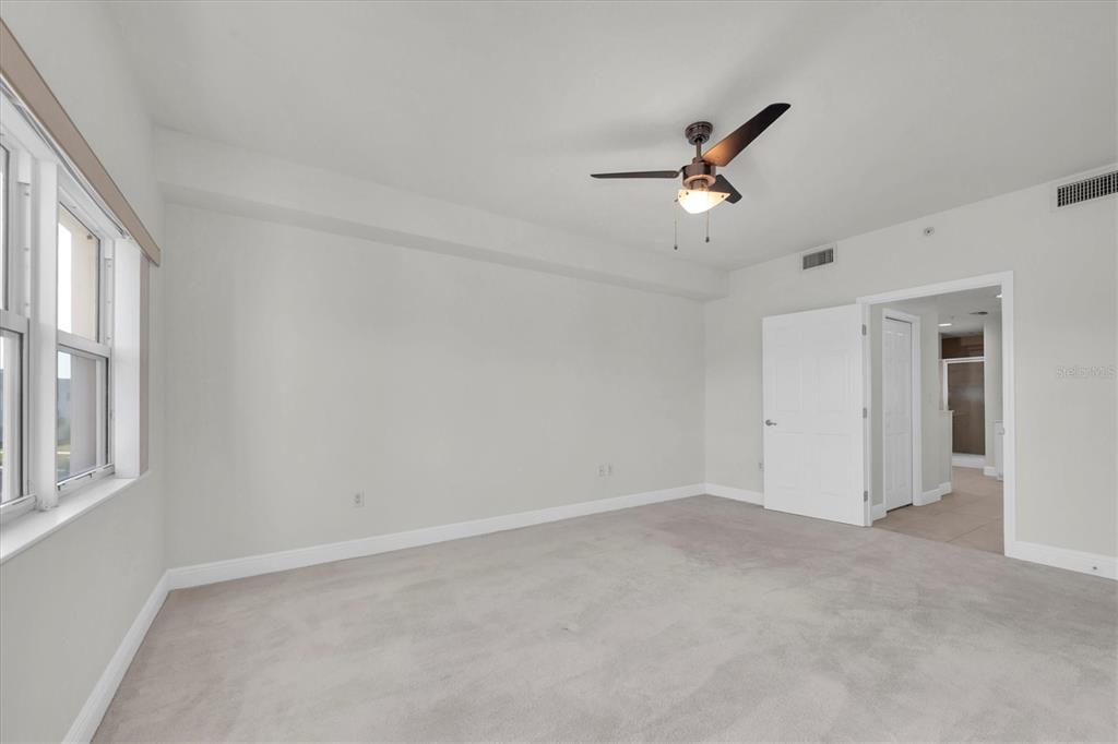 7069 Key Haven Road, Unit 302 Seminole, FL 33777 - Photo 24 of 65 an empty room with windows and fan