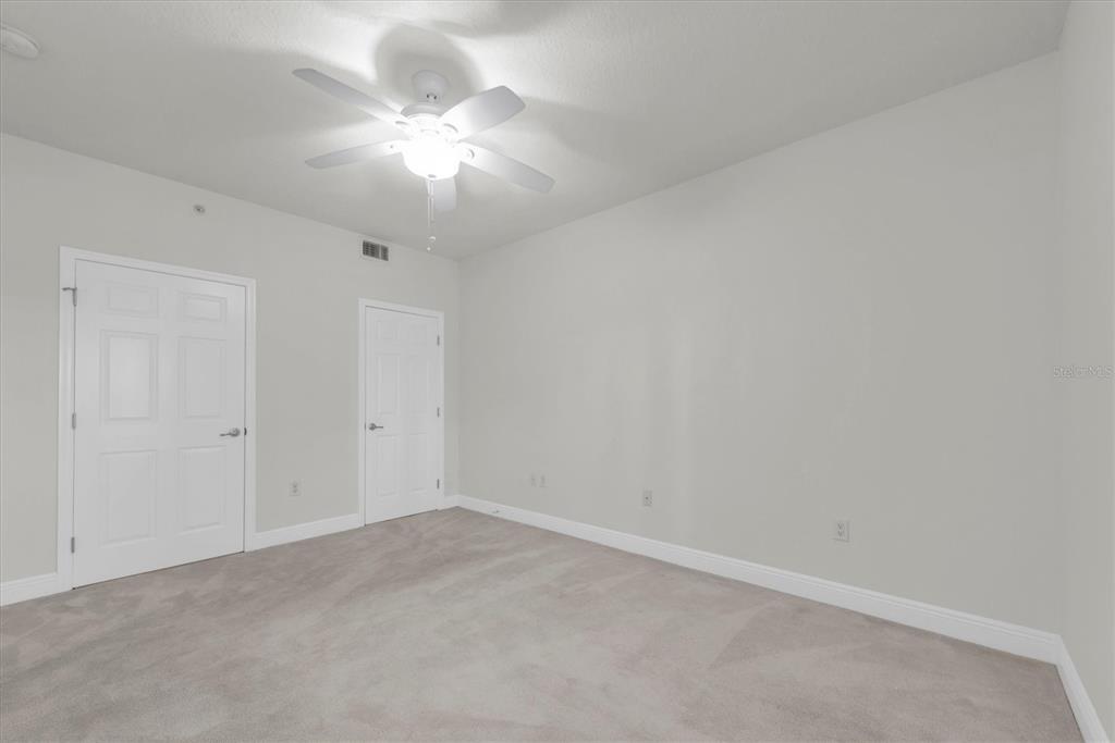 7069 Key Haven Road, Unit 302 Seminole, FL 33777 - Photo 29 of 65 an empty room with a chandelier fan