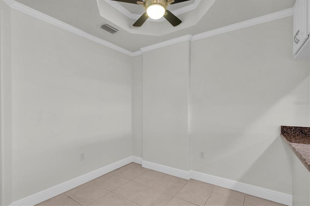 7069 Key Haven Road, Unit 302 Seminole, FL 33777 - Photo 31 of 65 an empty room with a ceiling fan and carpet