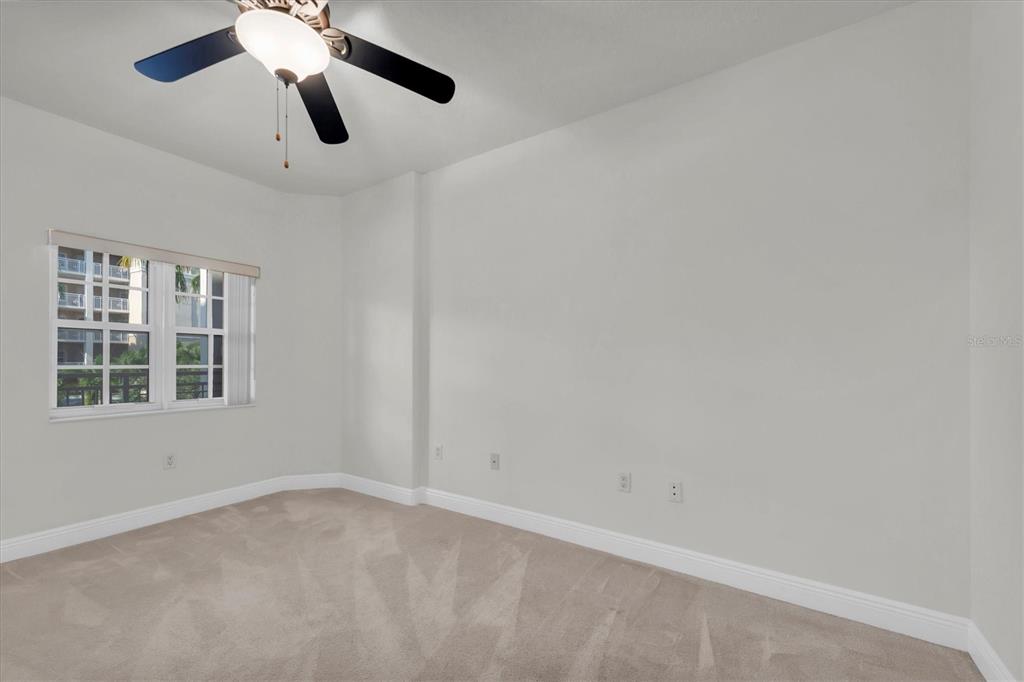 7069 Key Haven Road, Unit 302 Seminole, FL 33777 - Photo 32 of 65 an empty room with a window and a fan