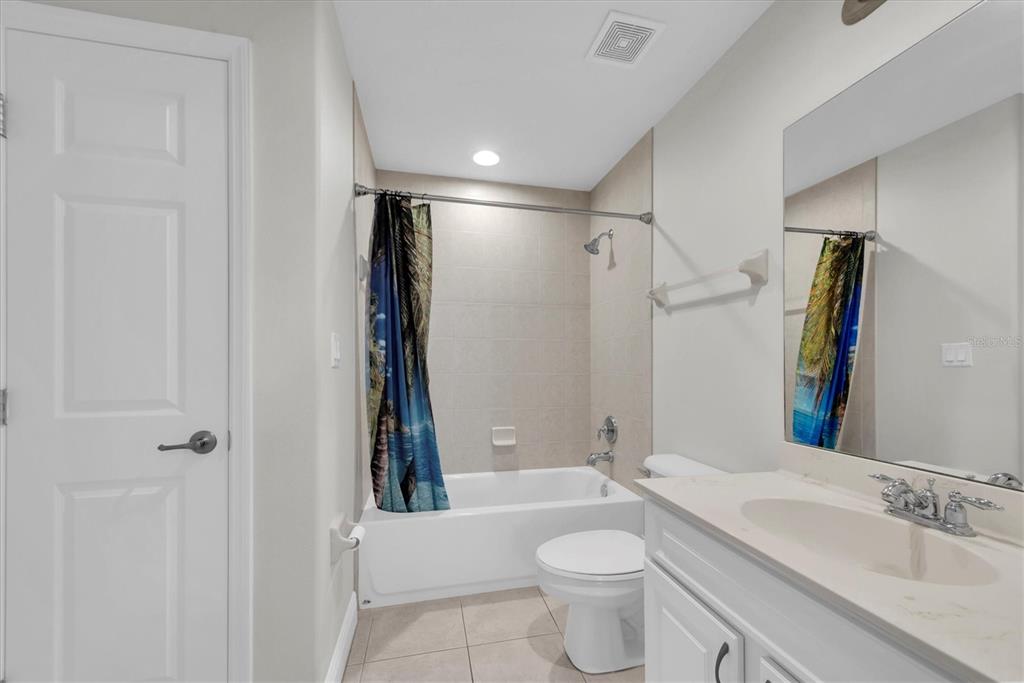 7069 Key Haven Road, Unit 302 Seminole, FL 33777 - Photo 33 of 65 a bathroom with a bathtub shower sink vanity mirror and toilet