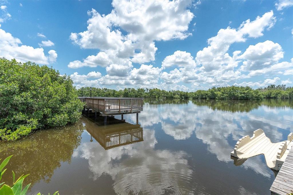 7069 Key Haven Road, Unit 302 Seminole, FL 33777 - Photo 61 of 65 a view of a lake with houses in the back