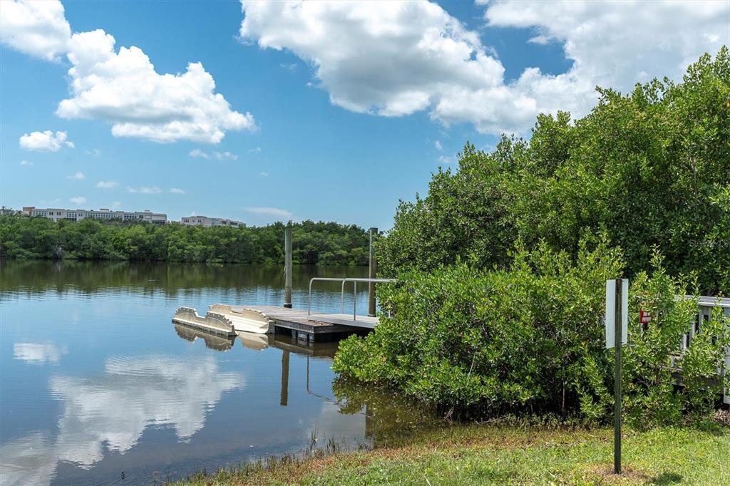 7069 Key Haven Road, Unit 302 Seminole, FL 33777 - Photo 62 of 65 a lake view with boat and trees in the background