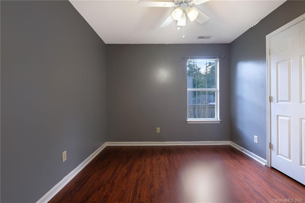 710 Foxborough Road Charlotte, NC 28213 - Photo 13 of 17 an empty room with wooden floor and windows