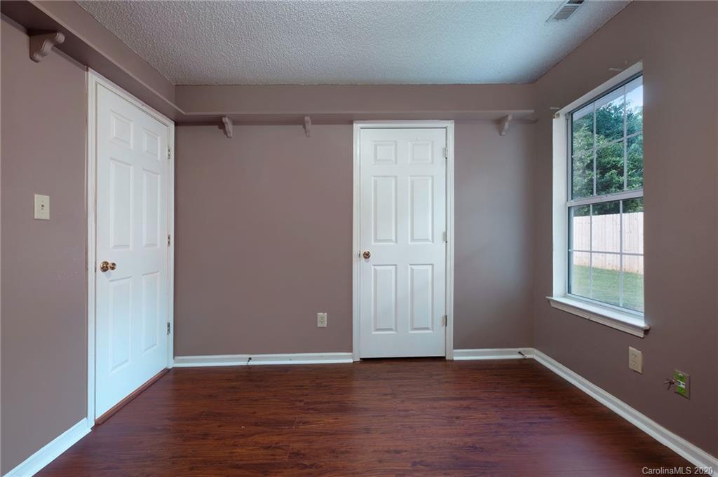 710 Foxborough Road Charlotte, NC 28213 - Photo 14 of 17 a view of an empty room with wooden floor and a window