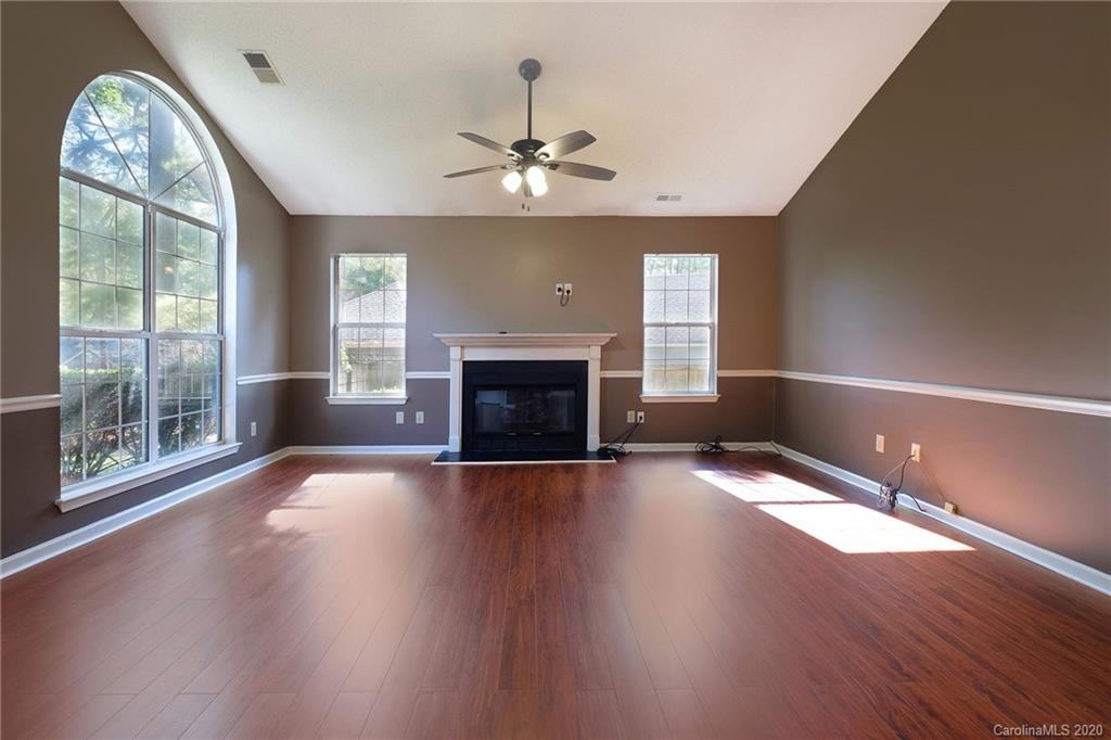 710 Foxborough Road Charlotte, NC 28213 - Photo 3 of 17 a view of an empty room with wooden floor fireplace and a window