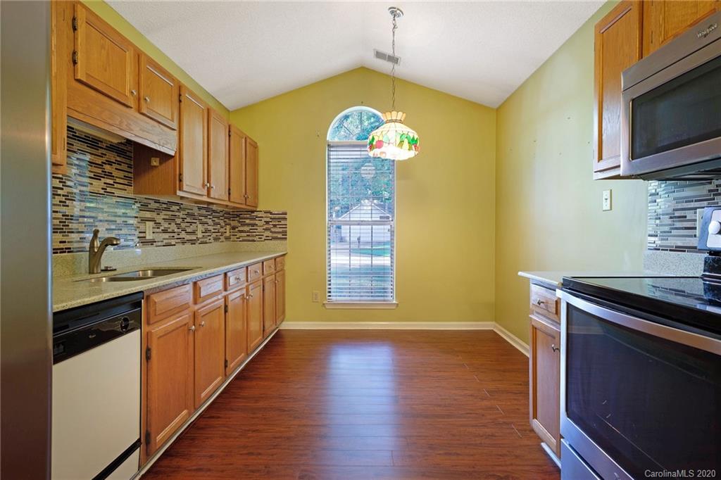 710 Foxborough Road Charlotte, NC 28213 - Photo 4 of 17 a kitchen with stainless steel appliances granite countertop a stove and a wooden floor