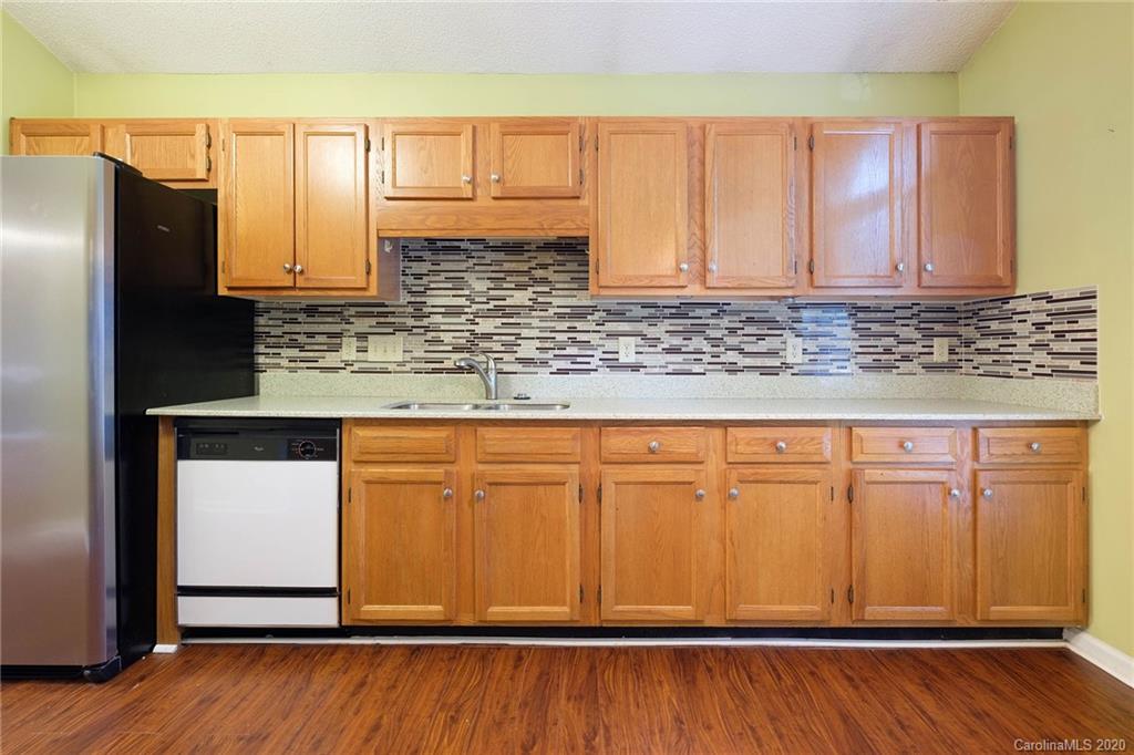 710 Foxborough Road Charlotte, NC 28213 - Photo 6 of 17 a view of a kitchen with granite countertop wooden cabinets and a wooden floor