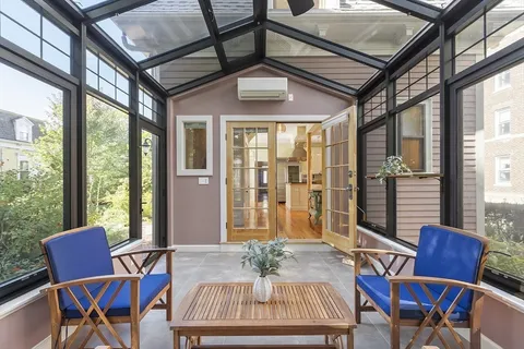 a view of a dining room with furniture large windows and wooden floor