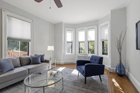 a living room with furniture and a large window