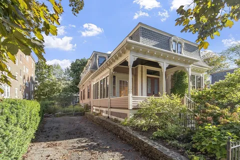 a front view of a house with garden