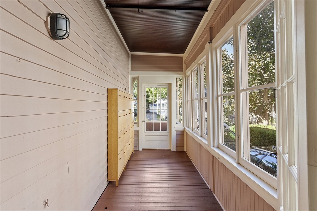 34 Day Street Somerville, MA 02144 - Photo 22 of 42 a view of a hallway with wooden floor and staircase