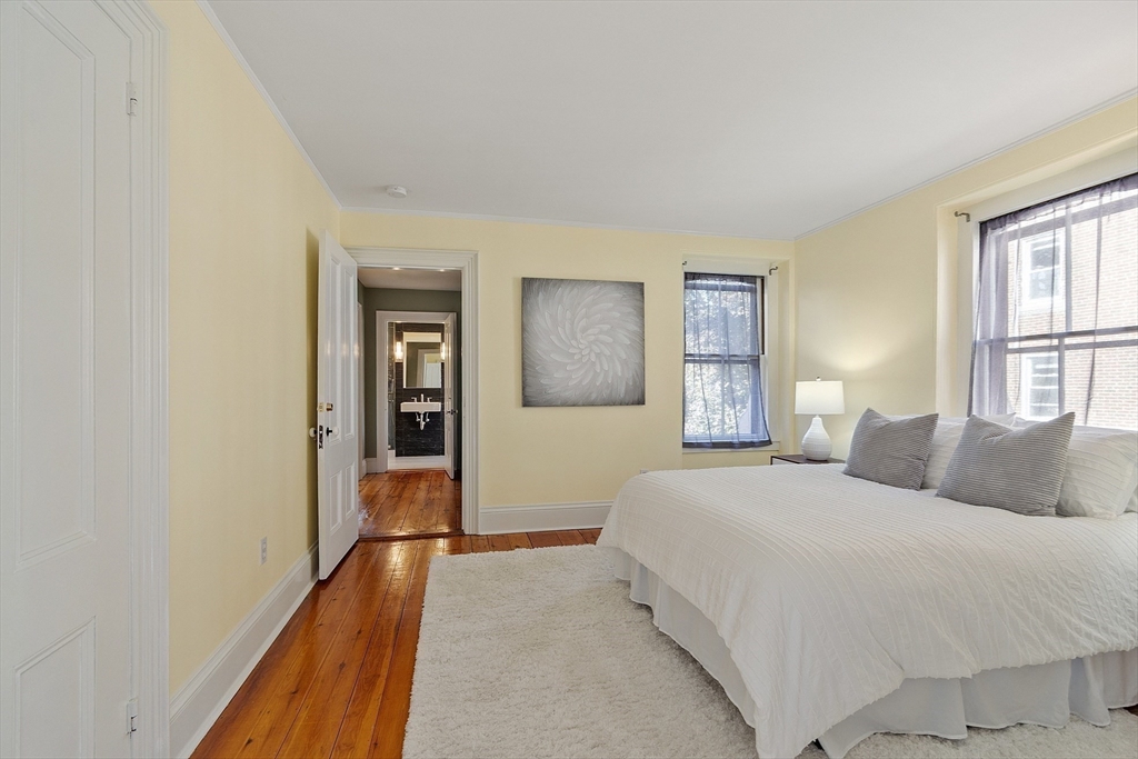 34 Day Street Somerville, MA 02144 - Photo 24 of 42 a bedroom with a bed and a painting on the wall