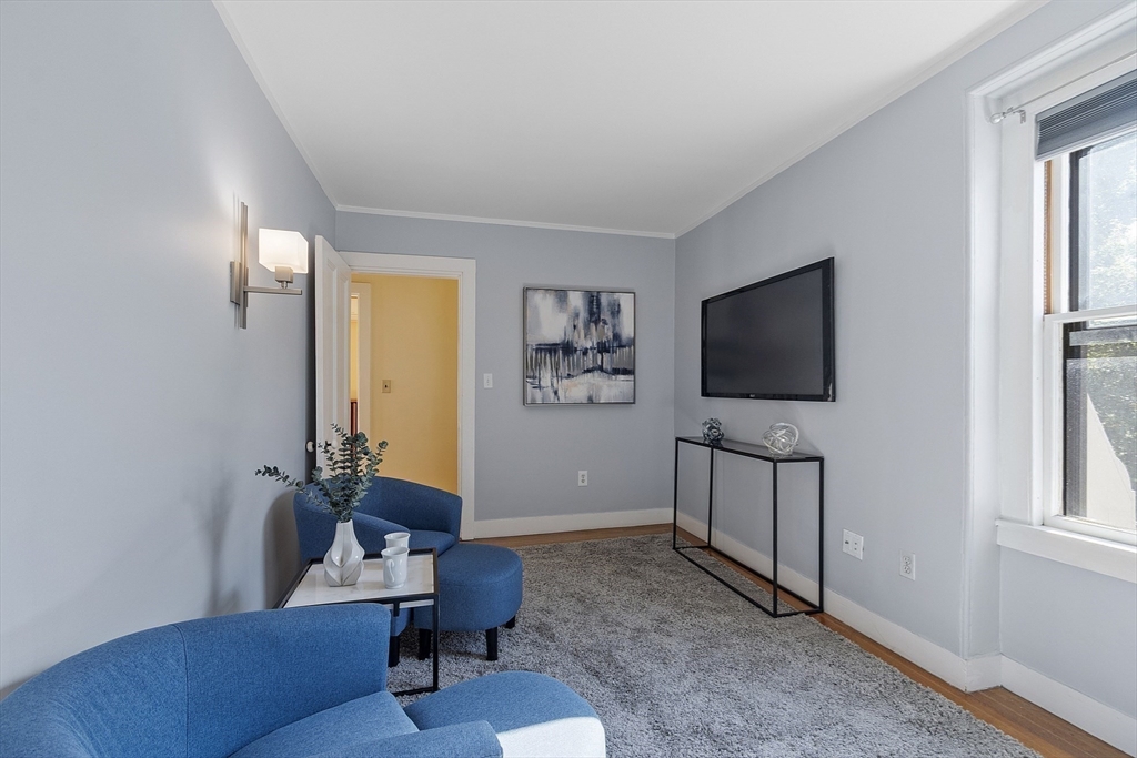 34 Day Street Somerville, MA 02144 - Photo 27 of 42 a living room with furniture and a flat screen tv