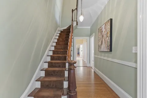 a view of entryway and hall with wooden floor