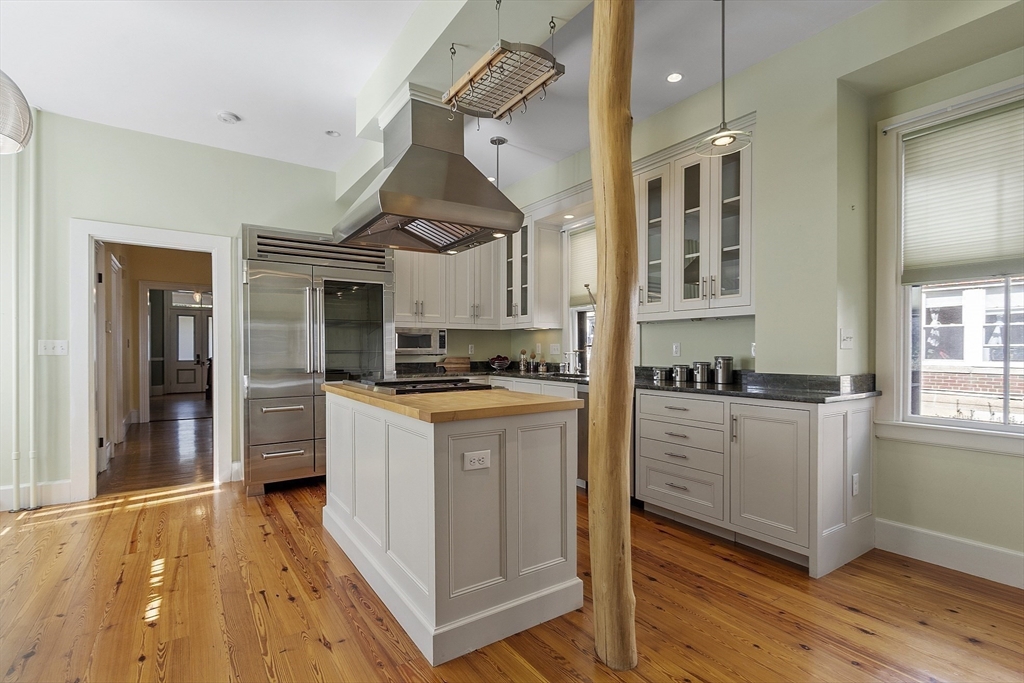 34 Day Street Somerville, MA 02144 - Photo 5 of 42 a kitchen with stainless steel appliances granite countertop a stove and cabinets