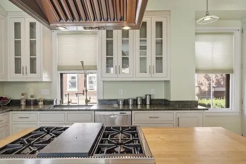 a kitchen with stainless steel appliances granite countertop a stove a sink and a granite counter tops