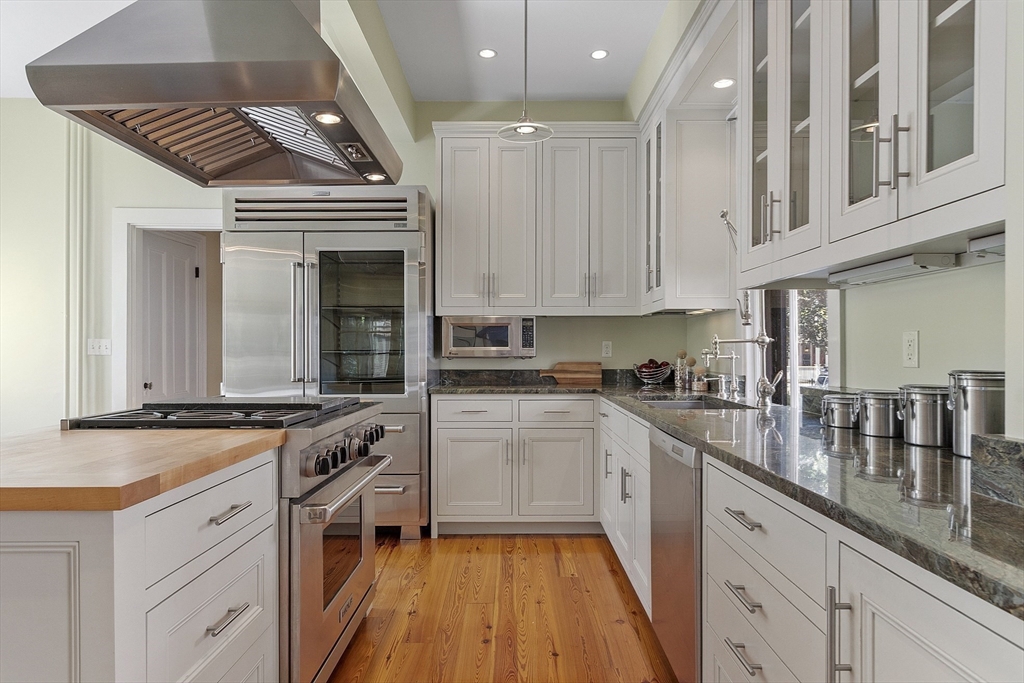 34 Day Street Somerville, MA 02144 - Photo 8 of 42 a kitchen with stainless steel appliances granite countertop a stove and cabinets