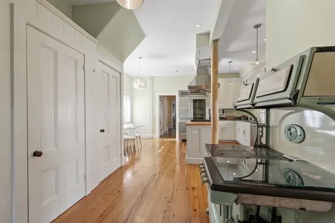 a view of a hallway with entryway wooden floor and front door