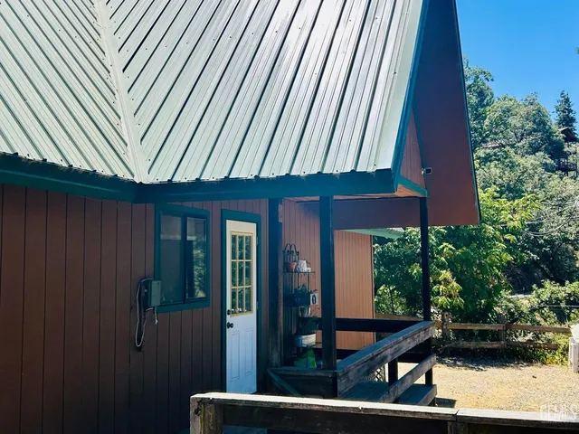 a backyard of a house with a yard and outdoor seating