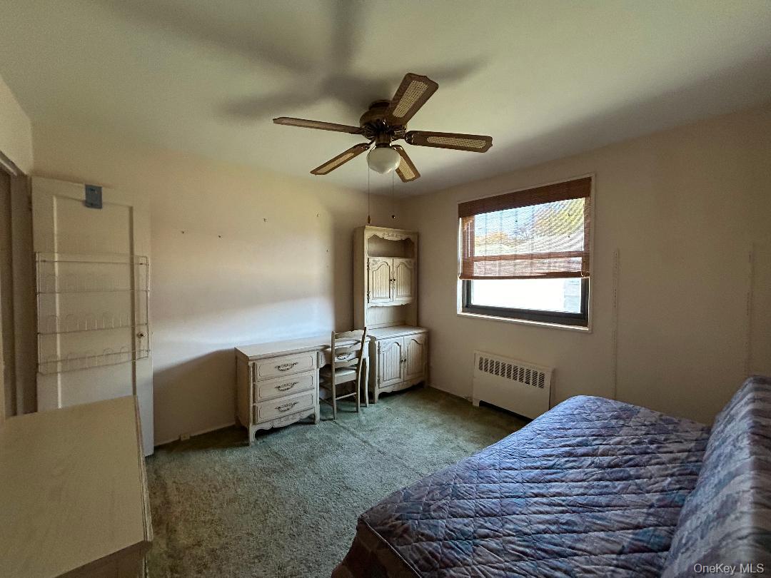 17-15 160th Street, Unit 594 Queens, NY 11357 - Photo 11 of 24 a bedroom with a bed and a window